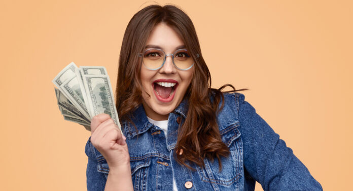 Excited plus size woman with money